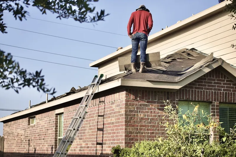 Professional roofer working on a residential roof in Blair Estates